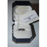 A WHITE METAL AND THIRTEEN STONE DIAMOND SET RING