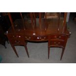 20TH CENTURY MAHOGANY SERPENTINE FRONTED DRESSING TABLE WITH FIVE FRIEZE DRAWERS SUPPORTED ON SQUARE