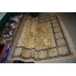 BEIGE GROUND EASTERN PATTERNED RUG WITH GEOMETRIC DESIGN BORDERS AND LARGE CENTRAL PANEL OF MIXED