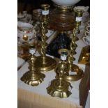 PAIR OF BRASS BARLEY TWIST CANDLESTICKS, TOGETHER WITH A PAIR OF BRASS GEORGIAN STYLE CANDLE STICKS