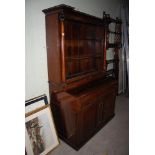 AN UNUSUAL MAHOGANY BOOKCASE, THE LOWER SECTION WITH PANELLED DOORS AND BOWED CUPBOARD REVELLING