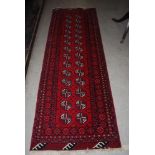 PAIR OF RED GROUND EASTERN PATTERNED RUNNERS WITH GEOMETRIC DESIGN BORDERS AND CENTRAL PANEL OF