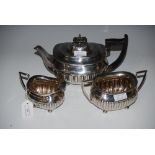 SHEFFIELD SILVER THREE PIECE TEA SET, OVAL WITH PART GADROONED DECORATION, ON FOUR BUN FEET