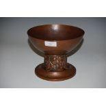 AN ARTS & CRAFTS HAMMERED COPPER FOOTED BOWL IN THE MANNER OF THE KESWICK SCHOOL OF INDUSTRIAL