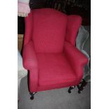 RED UPHOLSTERED WING BACK LOUNGE EASY CHAIR ON CABRIOLE LEGS