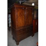 A 19TH CENTURY MAHOGANY TWO PART LINEN PRESS WITH DENTIL CORNICE, ON SQUARE BRACKET FEET