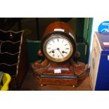WALNUT CASED MANTEL CLOCK WITH WHITE ENAMEL DIAL AND ROMAN NUMERALS