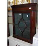 A 20TH CENTURY MAHOGANY HANGING CORNER CABINET WITH GLAZED ASTRAGAL DOOR