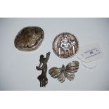 WHITE METAL SCANDINAVIAN CIRCULAR BROOCH WITH CHASED DECORATION OF BEARDED FIGURE SITTING ON A