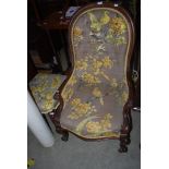 A 19TH CENTURY MAHOGANY FRAMED BUTTON BACK NURSERY CHAIR WITH SERPENTINE FRONT, ON CARVED CABRIOLE