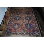 ASIAN PATTERNED BLUE GROUND RUG WITH GEOMETRIC DESIGN BORDER AND CENTRAL PANEL OF SIX MEDALLIONS