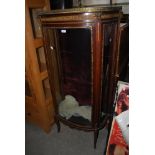 A 19TH CENTURY FRENCH WALNUT AND GILT BOW FRONT DISPLAY CABINET WITH RED MARBLE TOP AND BRASS
