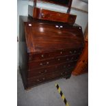 A 19TH CENTURY MAHOGANY WRITING BUREAU WITH FOUR FRIEZE DRAWERS, SUPPORTED ON BRACKET FEET