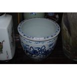 CHINESE BLUE AND WHITE JARDINIERE DECORATED WITH DRAGONS AND MIXED FOLIAGE