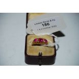 THREE STONE RUBY AND DIAMOND CHIP DRESS RING SET TO 18CT GOLD BAND