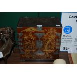 LACQUERED CHINESE TABLE CABINET WITH TWO PANELLED DOORS AND ONE FRIEZE DRAWER, DECORATED WITH EXOTIC