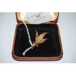 YELLOW METAL AND PEARL SET LEAF SHAPED BROOCH STAMPED 9CT