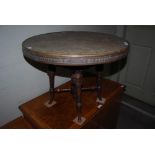 EASTERN CIRCULAR BRASS TOP ADJUSTABLE OCCASIONAL TABLE ON STAINED OAK CARVED BASE