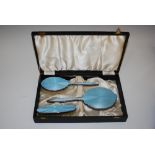WHITE METAL AND SKY BLUE ENAMEL THREE PIECE DRESSING TABLE SET COMPRISING MIRROR AND TWO BRUSHES