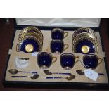 CASED ROYAL WORCESTER COBALT BLUE GROUND COFFEE SET WITH WHITE JEWELED BORDERS AND RICHLY GILDED
