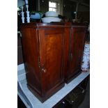 NEAR PAIR OF MAHOGANY BEDSIDE CABINETS WITH PANELLED DOORS ON SQUARE PLATFORM BASES