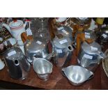 EIGHT PIECES OF PICQUOT WARE INCLUDING TEA POTS, HOT WATER JUGS, SUGAR AND CREAM, ETC.