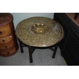 EASTERN BRASS TOP OCCASIONAL TABLE ON CARVED WOODEN BASE