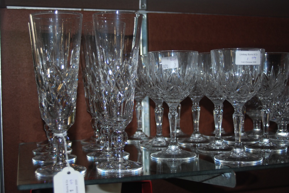 LARGE COLLECTION OF ASSORTED CUT GLASSWARE INCLUDING CHAMPAGNE FLUTES, WINE GOBLETS, ETC.