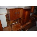 STAINED MAHOGANY SIDE CABINET WITH PANELLED DOOR, TOGETHER WITH A WALNUT TWO DOOR BEDSIDE CABINET ON