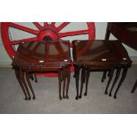 TWO REPRODUCTION MAHOGANY NEST OF THREE TABLES WITH GLAZED INSET TOPS