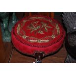 A 19TH CENTURY WALNUT FRAMED CIRCULAR FOOT STOOL WITH EMBROIDERED BEADWORK TOP