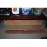 TWO MACHINE WOVEN FIRESIDE RUGS - ONE RED GROUND, THE OTHER BEIGE GROUND