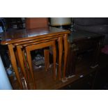 YEW WOOD NEST OF THREE TABLES, TOGETHER WITH A MAHOGANY AND BRASS BOUND NEST OF THREE TABLES WITH
