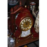TWO REPRODUCTION MANTEL CLOCKS - ONE IN A PUCE AND GILT LACQUERED CASE WITH WALL BRACKET, THE