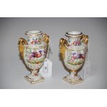 PAIR OF GOLD ANCHOR MARKED PORCELAIN TWIN HANDLED URNS DECORATED WITH COLOURFUL LONG TAILED BIRDS,
