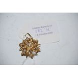 YELLOW METAL SPLIT PEARL AND DIAMOND SET STAR SHAPED BROOCH STAMPED 15CT