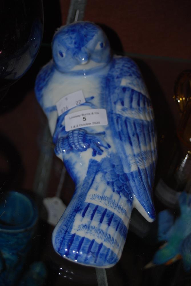 DECORATIVE BLUE AND WHITE PORCELAIN WALL POCKET IN THE FORM OF A BIRD OF PREY STANDING ON A BRANCH