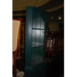 GREEN TINTED TWO PART CORNER CABINET WITH SINGLE FRIEZE DRAWER WITH PANELLED DOOR TOGETHER WITH
