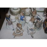 FOUR SPANISH NAO FIGURINES, TOGETHER WITH A LLADRO FIGURINE OF YOUNG GIRL PICKING FLOWERS