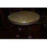 EASTERN BRASS TOPPED REVOLVING OCCASIONAL TABLE ON ASSOCIATED FOUR LEGGED BASE