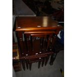 TWO NESTS OF THREE REPRODUCTION MAHOGANY OCCASIONAL TABLES