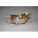 AN ARTS & CRAFTS BIRMINGHAM SILVER HAMMERED SAUCE BOAT, MAKERS MARK OF A.E. JONES