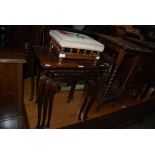 NEST OF THREE REPRODUCTION MAHOGANY OCCASIONAL TABLES, NEEDLEWORK UPHOLSTERED RECTANGULAR SPINDLE