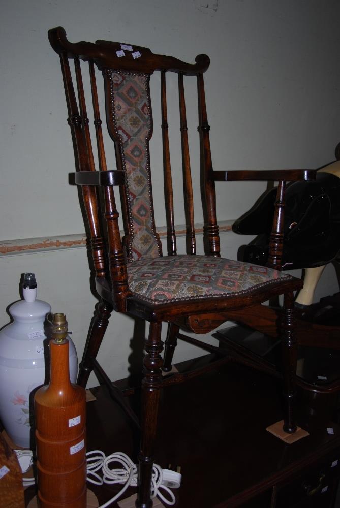 EARLY 20TH CENTURY STAINED BEECH ARMCHAIR WITH UPHOLSTERED CENTRAL SPLAT AND STUFFOVER SEAT