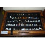 COLLECTION OF ASSORTED CERAMIC AND WHITE METAL THIMBLES, 104 IN TOTAL, IN OAK FRAMED WALL CABINET