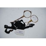 PAIR OF YELLOW METAL LORGNETTES, TOGETHER WITH A YELLOW METAL MAGNIFYING GLASS ON BLACK RIBBON