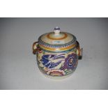 ART DECO POOLE POTTERY BISCUIT BARREL AND COVER DECORATED WITH STYLISED BIRDS AND FLOWERS, WITH