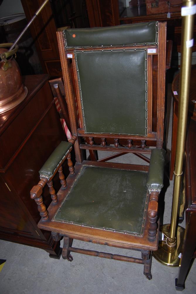 EARLY 20TH CENTURY STAINED BEECH AND GREEN LEATHERETTE UPHOLSTERED ROCKING CHAIR