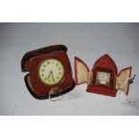 BRASS CASED TRAVELLING TIMEPIECE IN RED VELVET CASE BY HOME WATCH COMPANY, TOGETHER WITH AN EIGHT