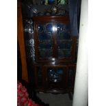 EDWARDIAN MAHOGANY BREAKFRONT DISPLAY CABINET IN THE ROCOCO STYLE, THE UPPER SECTION WITH BLUE